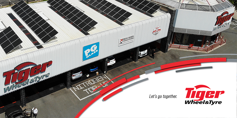 the roof of a tiger wheel and tyre store with solar panels
