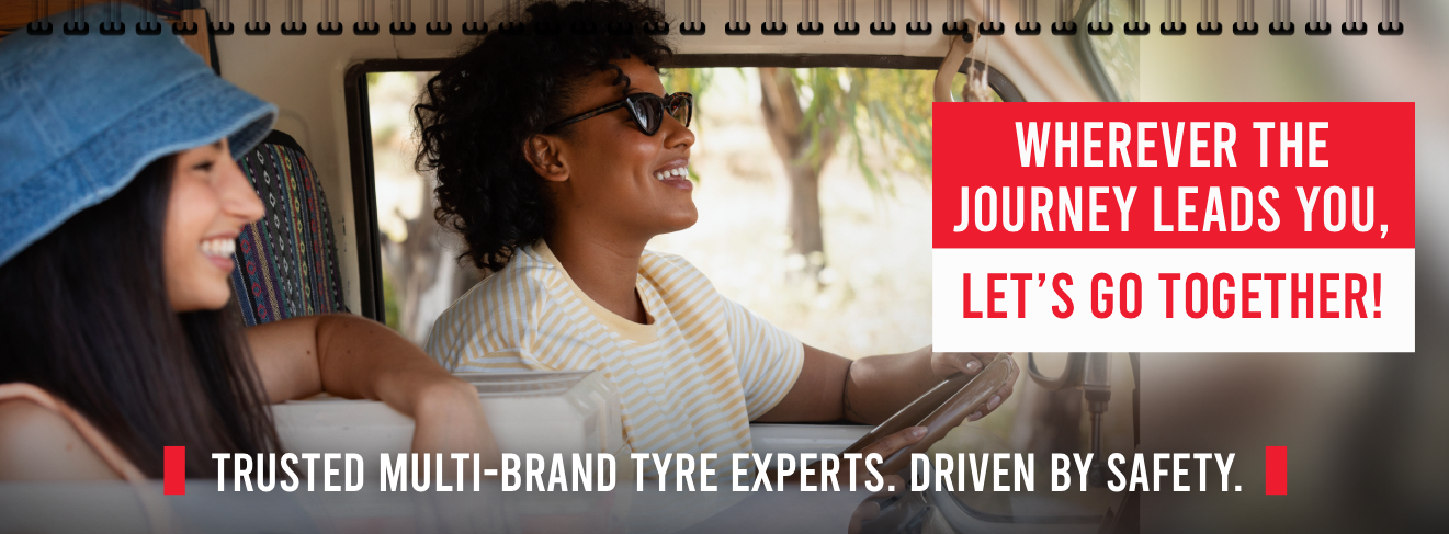 Two people smiling together inside a vehicle